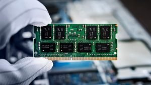 Hand,With,Memory,On,A,Computer,Motherboard.,Ram,In,Hand